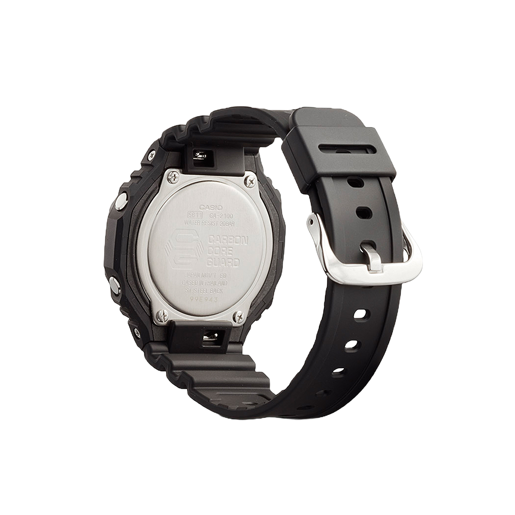 Um relógio Casio de resina com uma pulseira preta exibido contra um fundo simples. O relógio tem uma moldura redonda texturizada e uma fivela prateada. A parte traseira do relógio, visível nesta vista, mostra várias inscrições, incluindo o nome da marca, o número do modelo (3229) e informações sobre resistência à água (20 BAR
