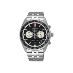 Um relógio Seiko de aço inoxidável com mostrador preto, apresentando múltiplos submostradores e um visor de data. O relógio possui uma pulseira metálica, ponteiros e marcadores de hora luminosos. O aro tem marcações de minutos e o mostrador inclui o logotipo da Seiko sob a posição das 12 horas.