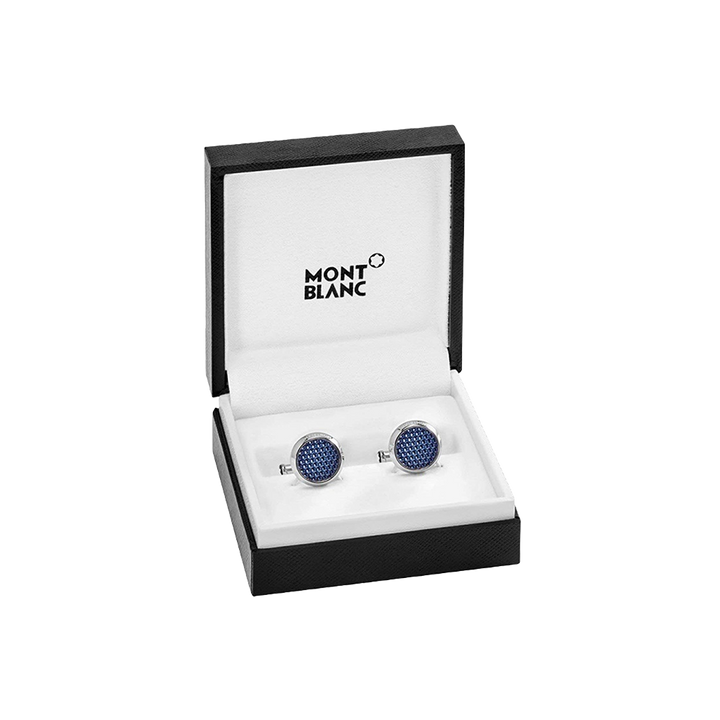 Um par de botões de punho da Montblanc com incrustações de cristal azul, apresentados numa caixa preta aberta com o logotipo da Montblanc no interior da tampa. Os botões de punho são redondos e parecem ser finamente trabalhados, refletindo a luz de suas superfícies multifacetadas, sugerindo um acessório luxuoso para trajes formais.
