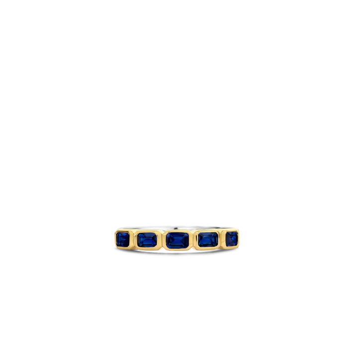 Imagem com vista superior de um anel de prata banhado a ouro amarelo, apresentando várias pedras retangulares de lapis lazuli dispostas em um engaste de canal, criando uma banda contínua de azul profundo ao longo da parte superior do anel. O contraste entre o banho de ouro amarelo e o rico azul das pedras de lapis lazuli torna esta peça visualmente impressionante.