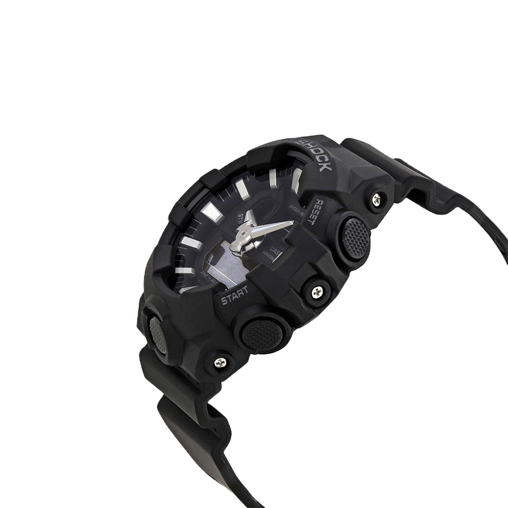 Relógio de pulso Casio G-Shock com bracelete de resina preta e design robusto. O mostrador combina displays analógicos e digitais, com ponteiros prateados e marcadores de hora sobre um fundo preto. O bisel é marcado com indicadores de minutos e a inscrição “SHOCK RESIST”. Funções adicionais incluem exibição de dia e data, além de configurações de alarme visíveis no mostrador.