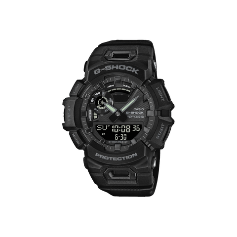 Relógio Casio G-Shock de resina preta com display digital-analógico. O design é robusto, com vários botões e detalhes texturizados nas laterais. A tela digital mostra a hora 10:08:36 e a data 6-30, indicando 30 de junho. Os ponteiros do relógio analógico estão próximos das marcas de 10 e 2 horas. A palavra ‘PROTECTION’ está destacada na parte inferior do mostrador, enfatizando sua construção durável